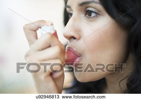 Drawing - Woman using inhaler. Fotosearch