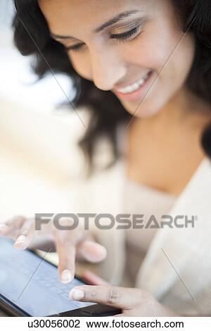 Drawing - Woman using tablet. Fotosearch