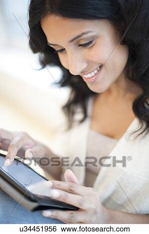 Stock Illustration - Woman using tablet. Fotosearch