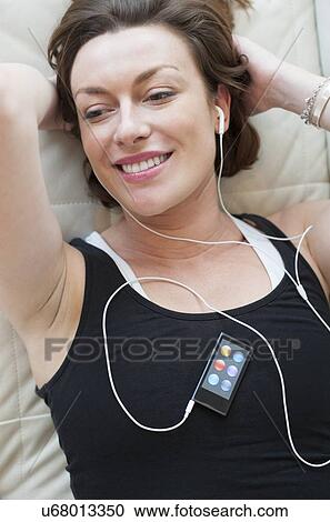 Clipart - Woman wearing earphones. Fotosearch