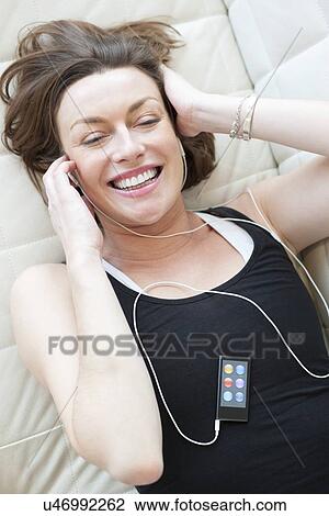 Drawing - Woman wearing earphones. Fotosearch