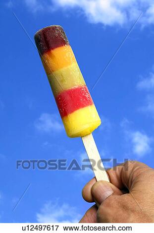 Stock Illustration - Person holding ice lolly. Fotosearch