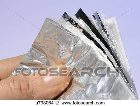 Drawing - Person holding multi-foil insulation, studio shot.. Fotosearch