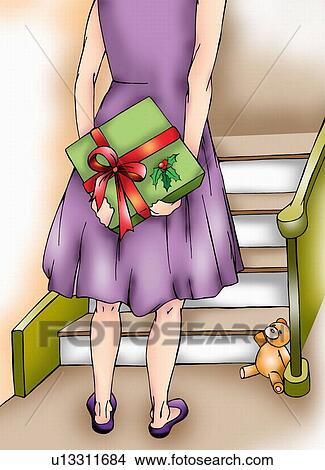 Stock Illustration - Woman holding a Christmas present behind her back. Fotosearch