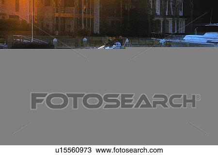 Drawing - boat in the ocean with buildings in background. Fotosearch