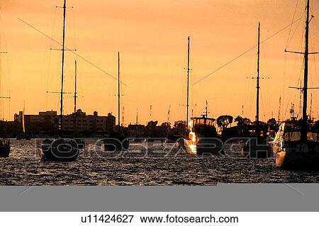 Stock Illustration - silhouttes of boats in ocean. Fotosearch