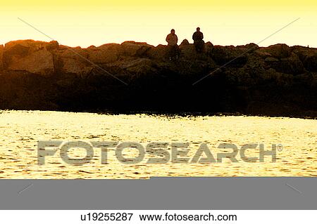 Stock Illustration - two silhouettes of people on the coast. Fotosearch