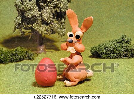 Bunny rabbit with egg View Large Illustration Stock Illustration - Bunny rabbit with egg. Fotosearch