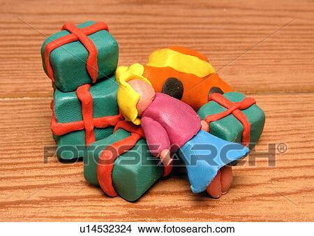 Stock Illustration - Presents with little girl doll. Fotosearch
