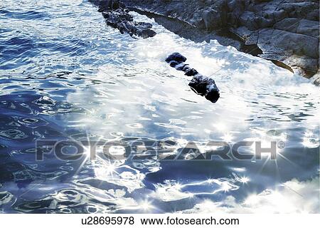 Stock Photo - The ocean surface, Japan, high angle view, composition, computer graphics, lens flare. Fotosearch