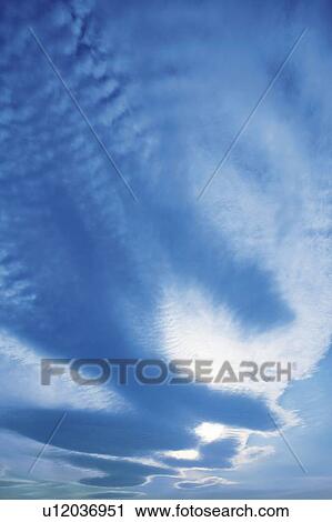 Stock Image - The sunlight through the clouds, Japan, low angle view, composition, computer graphics. Fotosearch