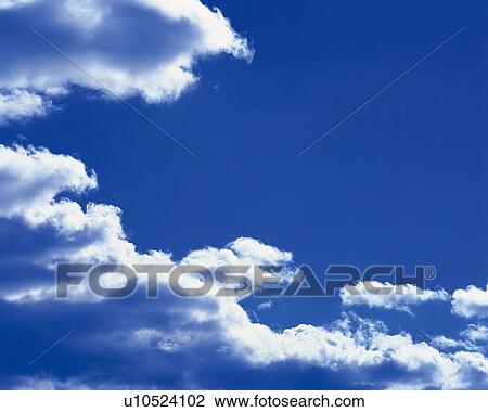 Stock Image - Blue sky and Clouds, Low angle view. Fotosearch