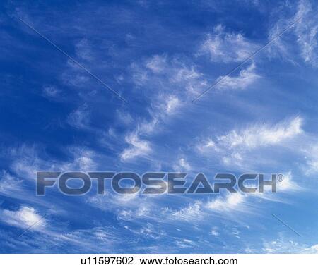 Stock Image - Blue sky and Clouds, Low angle view, Full frame. Fotosearch