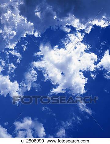 Stock Image - Blue sky and Clouds, Low angle view. Fotosearch