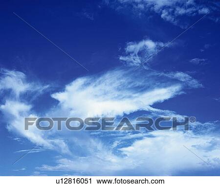 Stock Image - Blue sky and Clouds, Low angle view, Full frame. Fotosearch