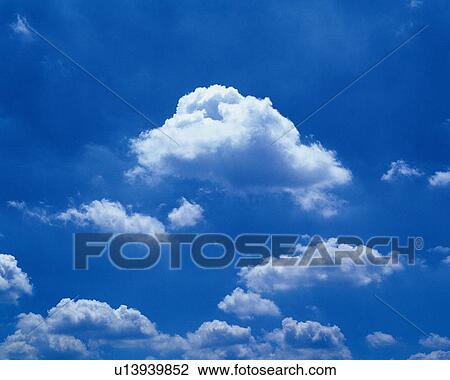 Stock Image - Blue sky and Clouds, Low angle view. Fotosearch