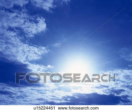 Stock Image - Blue sky and Clouds, Low angle view. Fotosearch