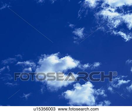 Stock Image - Blue sky and Clouds, Low angle view. Fotosearch