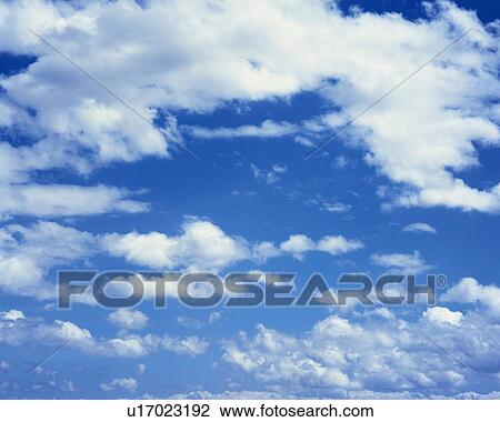 Stock Image - Blue sky and Clouds, Low angle view, Full frame. Fotosearch