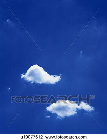 Stock Image - Blue sky and Clouds, Low angle view. Fotosearch
