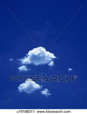 Stock Image - Blue sky and Clouds, Low angle view. Fotosearch