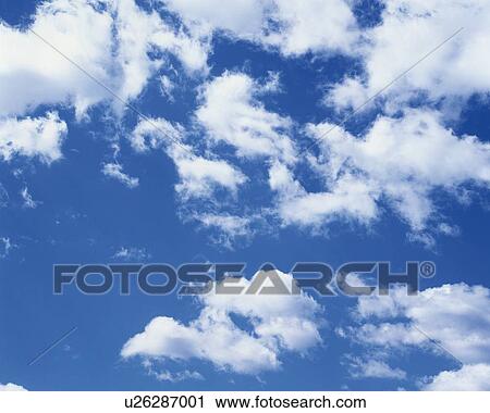 Stock Image - Blue sky and Clouds, Low angle view, Full frame. Fotosearch