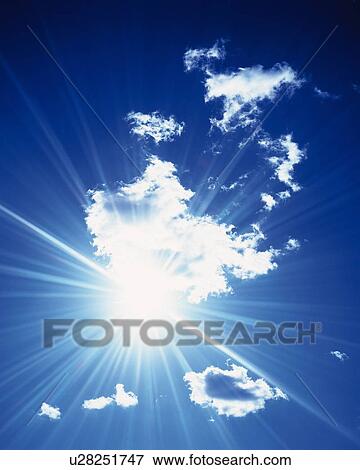 Stock Photo - Blue sky and Clouds, Low angle view, Lens Flare. Fotosearch