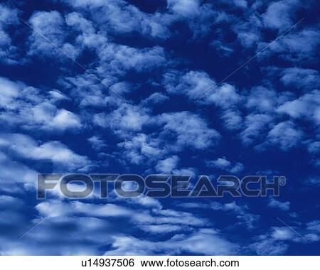 Stock Photograph - Blue sky and Clouds, Low angle view, Full frame. Fotosearch
