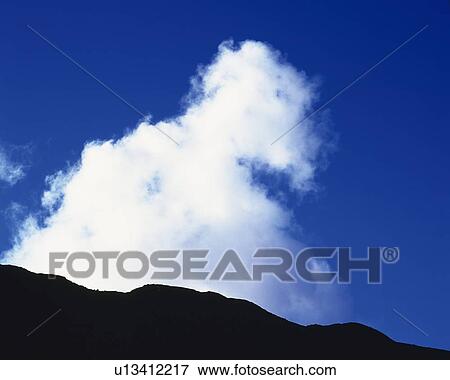 Stock Photo - Blue sky and Clouds with Mountains, Low angle view, . Fotosearch