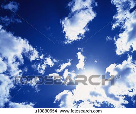 Picture - Blue sky and Clouds with Sun, Low angle view. Fotosearch