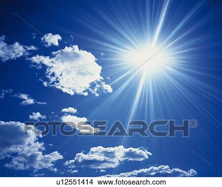 Picture - Blue sky and Clouds with Sun, Low angle view, Lens Flare. Fotosearch