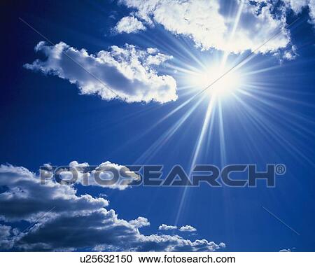 Stock Image - Blue sky and Clouds with Sun, Low angle view, Lens Flare. Fotosearch