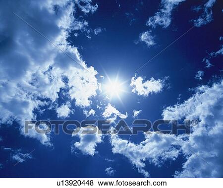 Stock Photo - Blue sky and Clouds with Sun, Low angle view, Lens Flare, Full Frame. Fotosearch