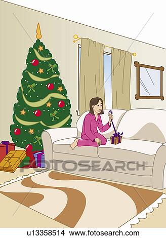 Stock Illustration - Girl in pajamas on couch opening a Christmas present. Fotosearch