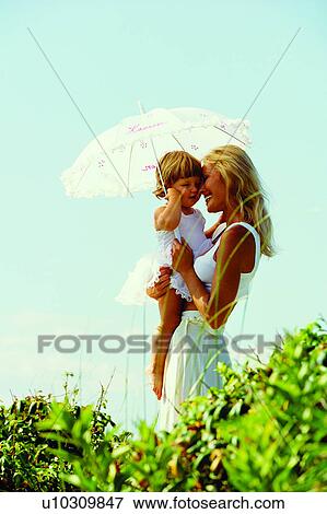 Umbrellas, People, Plants, Baby, Humans, Babies, Woman View Large Photo Image Stock Photo - Umbrellas, People, Plants, Baby, Humans, Babies, Woman. Fotosearch