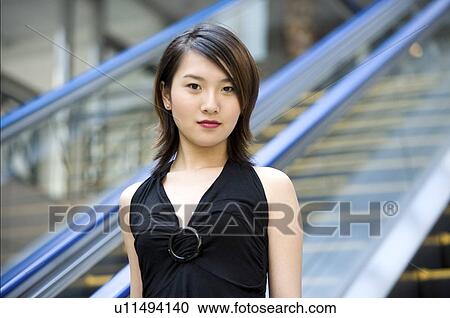 Stock Image - Young woman in front of lift. Fotosearch