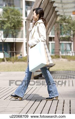 Young woman on the phone with shopping bags View Large Photo Image Stock Photo - Young woman on the phone with shopping bags. Fotosearch