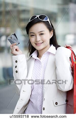 Young woman showing her bank cards with shopping bags View Large Photo Image Stock Photo - Young woman showing her bank cards with shopping bags. Fotosearch