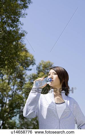 Young woman drinking water View Large Photo Image Stock Photograph - Young woman drinking water. Fotosearch
