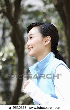 Young woman jogging outdoors View Large Photo Image Stock Photo - Young woman jogging outdoors. Fotosearch