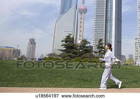 Young woman jogging, Shanghai skyline in background View Large Photo Image Stock Photo - Young woman jogging, Shanghai skyline in background. Fotosearch