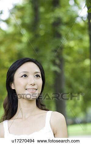 Young woman outdoors View Large Photo Image Picture - Young woman outdoors. Fotosearch