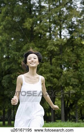 Stock Photography - Young woman running outdoors. Fotosearch