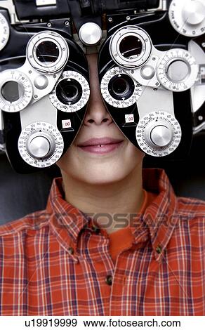 Stock Photo - Boy getting eye exam. Fotosearch