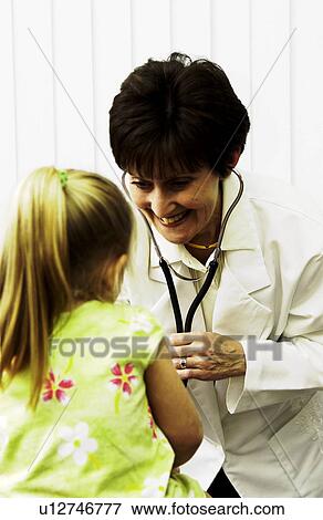 Stock Photo - Doctor examining child. Fotosearch