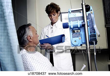 Stock Photo - Doctor talking with patient. Fotosearch