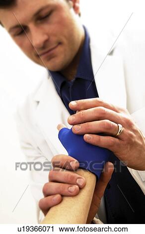 Doctor treating patient View Large Photo Image Stock Image - Doctor treating patient. Fotosearch