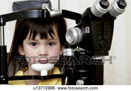 Girl getting vision tested View Large Photo Image Stock Photograph - Girl getting vision tested. Fotosearch
