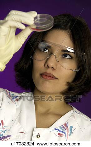 Picture - Lab technician examining slide. Fotosearch