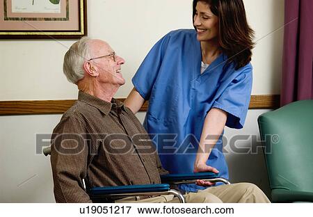 Man in wheelchair with nurse View Large Photo Image Stock Photo - Man in wheelchair with nurse. Fotosearch